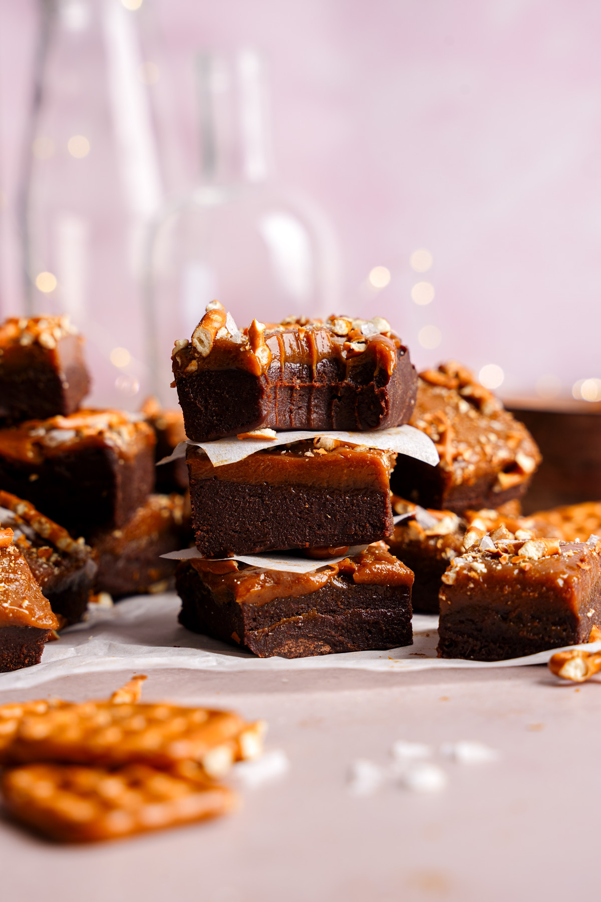 the date fudge pieces stacked on top of each other with a bite taken out of one to show the fudgy texture