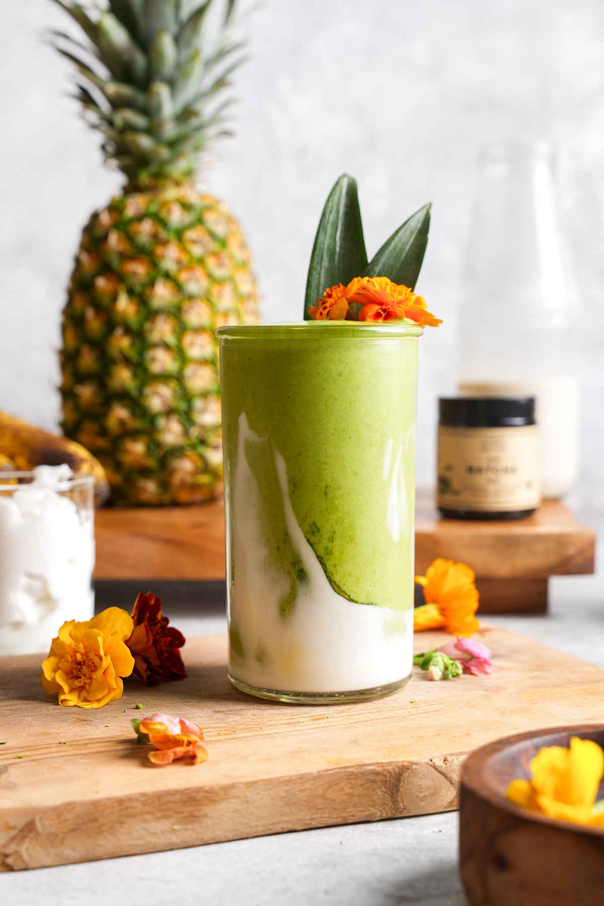 the matcha smoothie reci[e with the fresh smoothie ingredients all around it