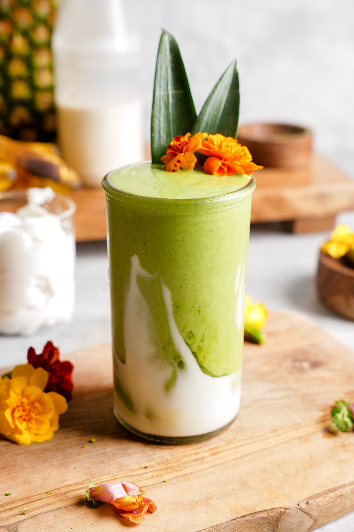 the matcha smoothie poured in a glass with coconum. t yogurt