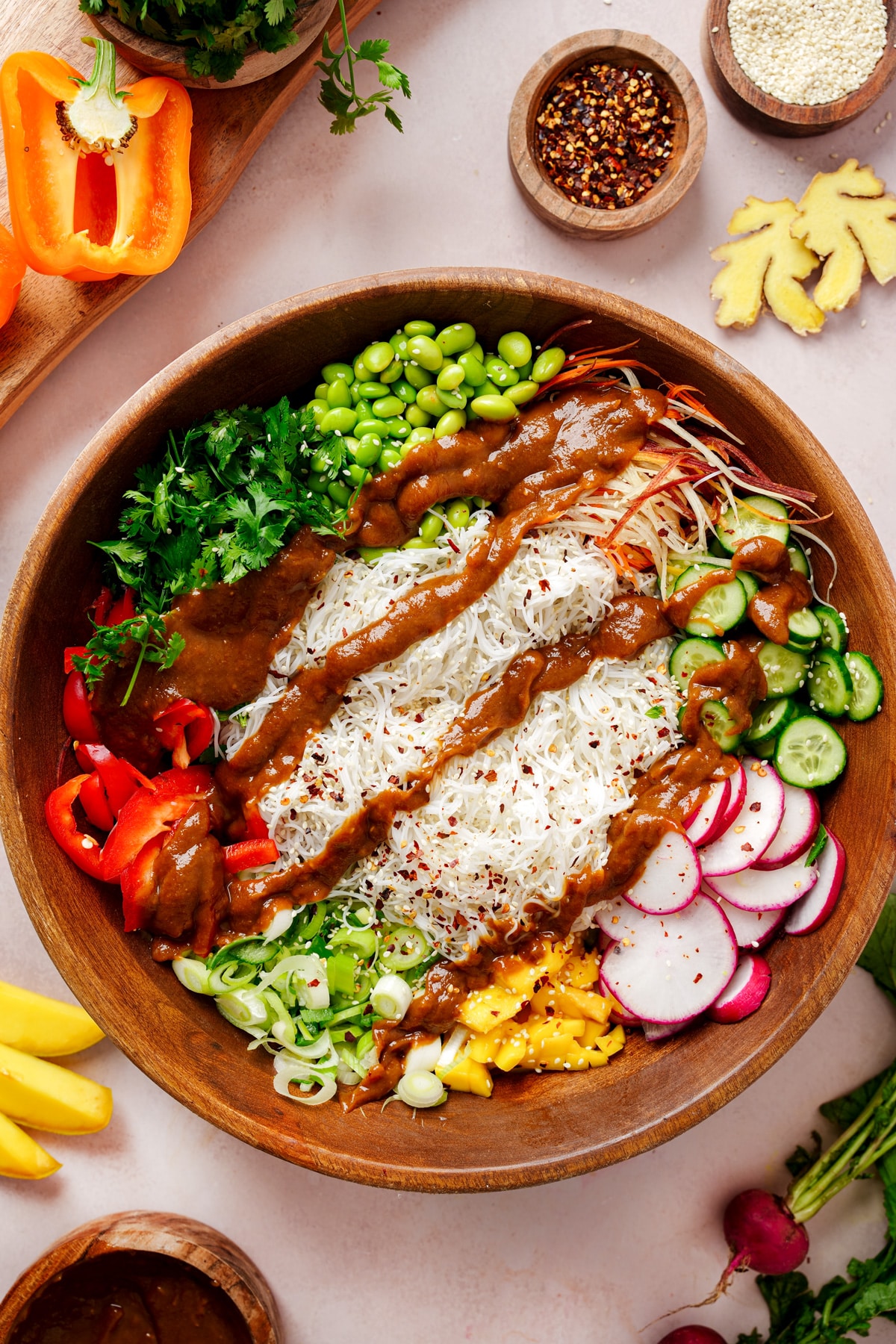 the spring roll salad in a large salad bowl the the peanut dressing on top