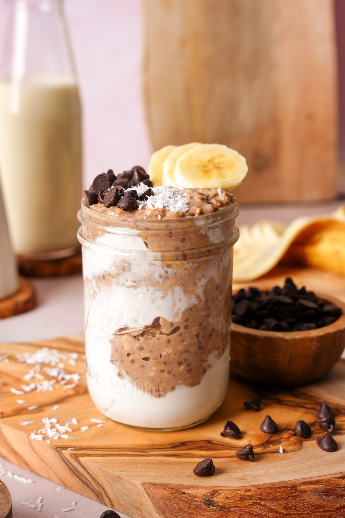 a close up of the chocolate overnight oats in a mason jar to show the creamy texture