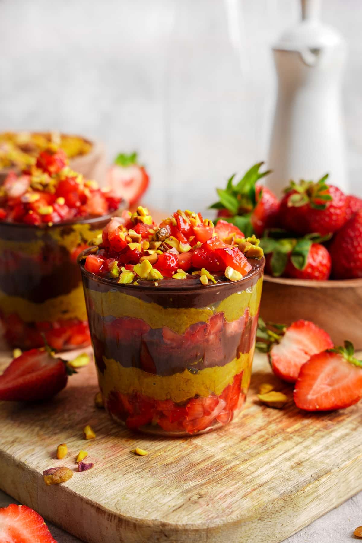 the dubai chocolate strawberries in a glass jar to show the layers of chocolate, pistachio and strawberries