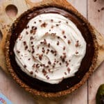 black sapote chocolate pie topped with whipped cream and chocolate shavings
