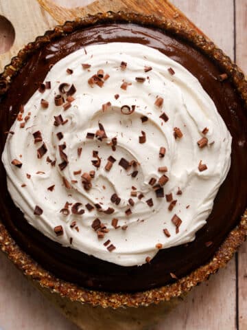black sapote chocolate pie topped with whipped cream and chocolate shavings
